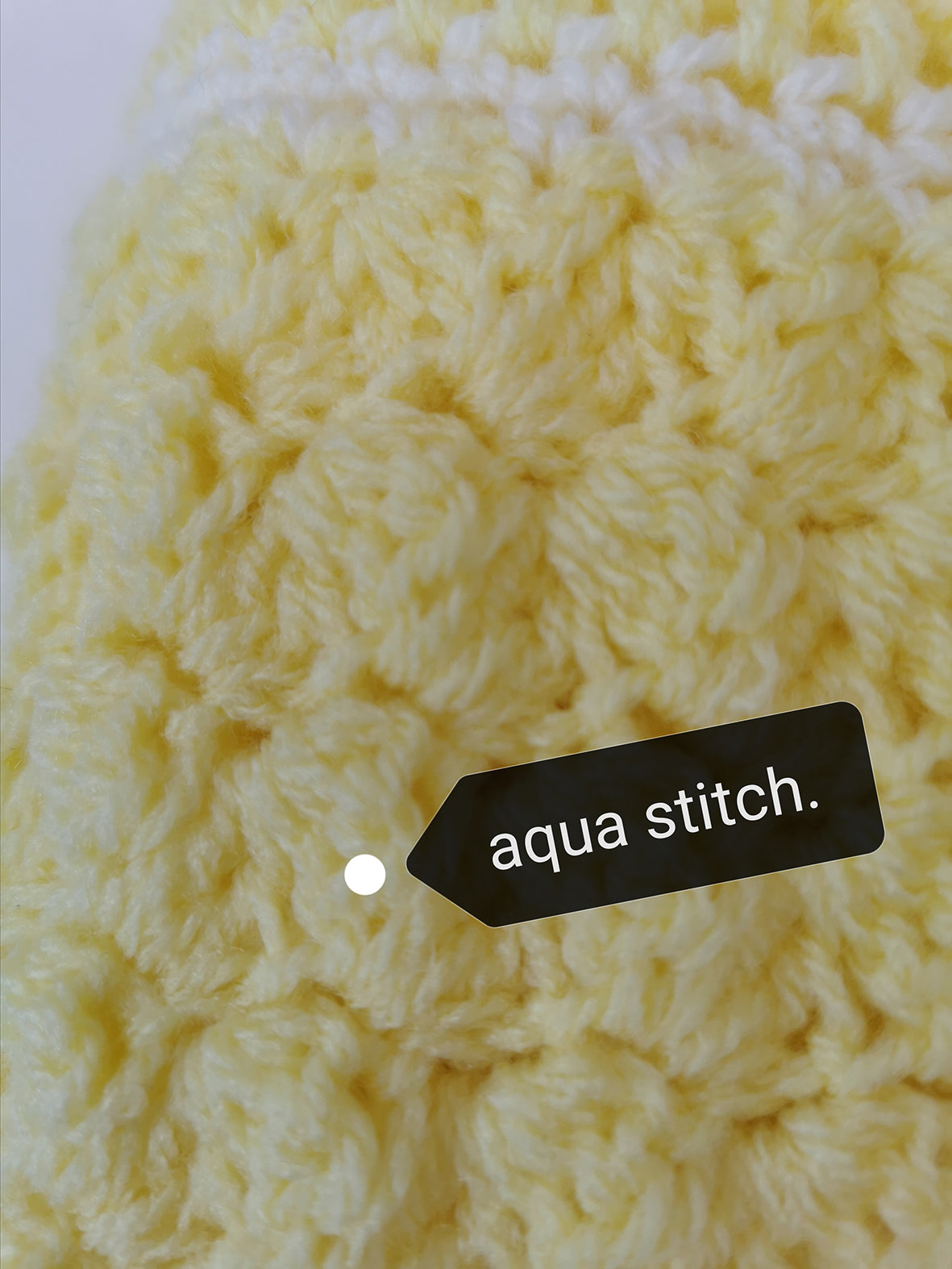 A lovely yellow crochet blanket made for baby using the aqua stitch. Trimmed with a white border.
